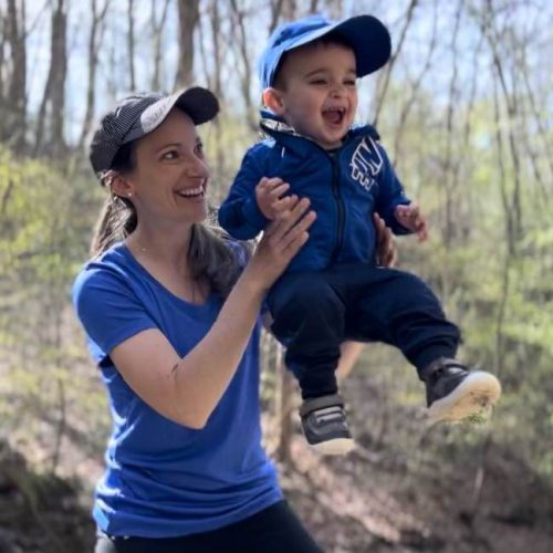 an occupational therapist bouncing a child in the air