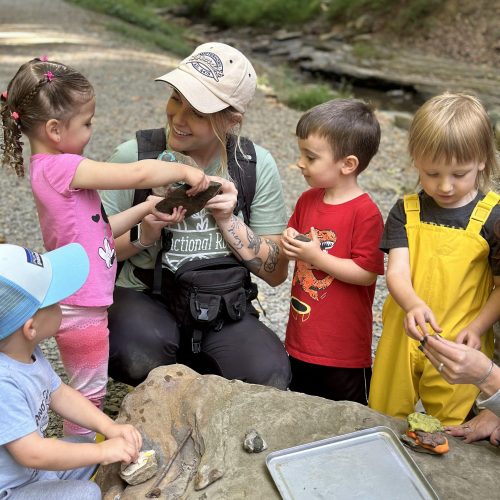 teacher working with kids outdoors